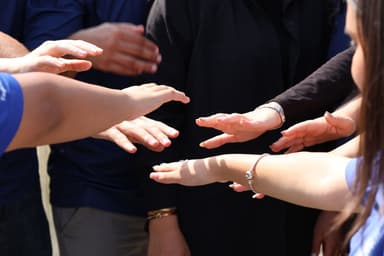 Groep mensen legt de handen op elkaar