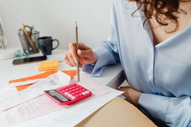 Rekeningen en rekenmachine op tafel bij het maken van een budget